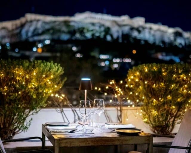 Rooftop dining area at The Zillers restaurant with Acropolis view in Athens.