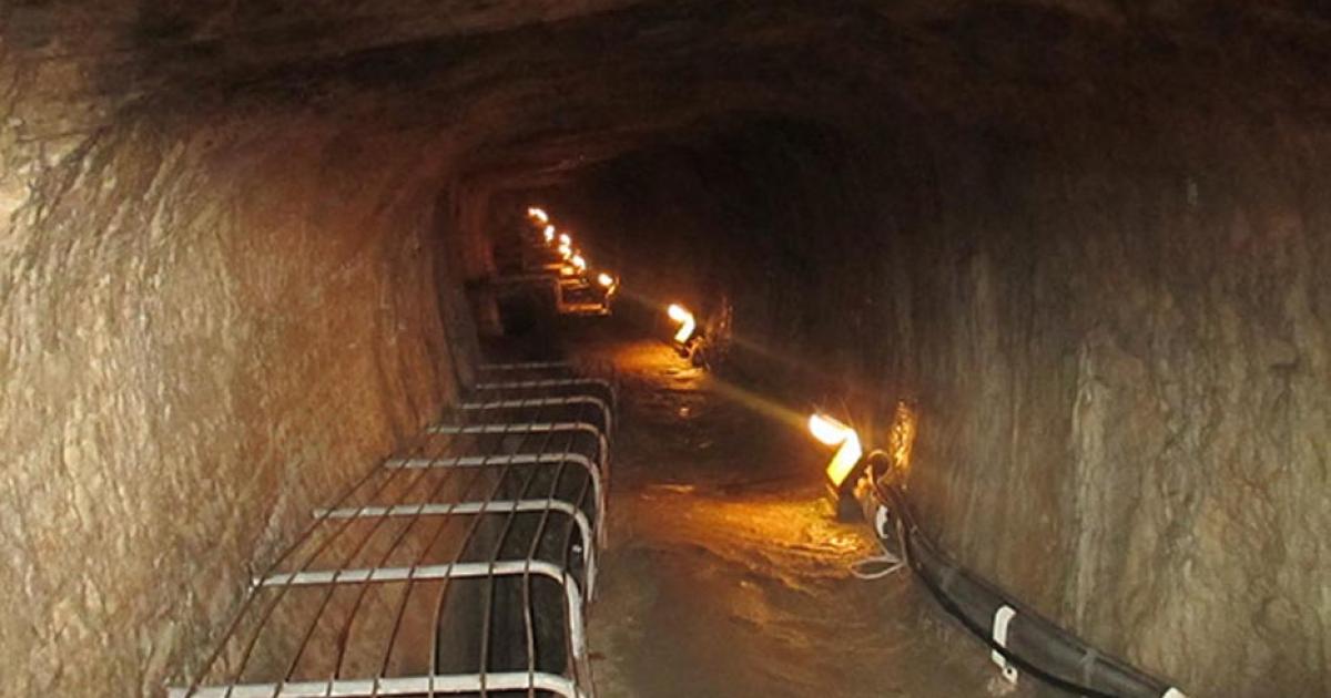 Interior view of the Tunnel of Eupalinos showing the narrow stone passageway carved through limestone.