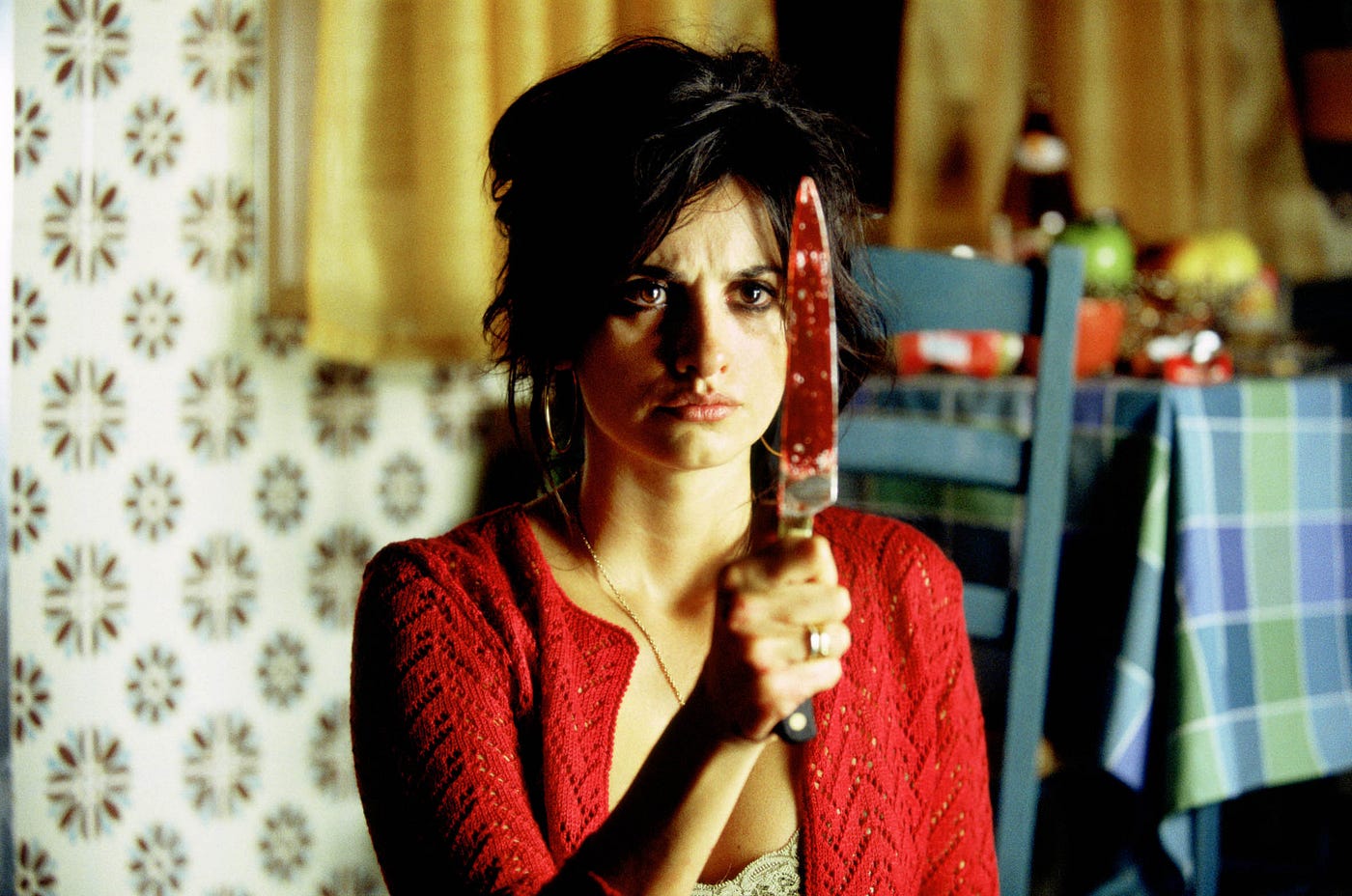Volver movie poster featuring Penélope Cruz smilingCaption: Poster of Volver, a drama about family and forgiveness starring Penélope Cruz.