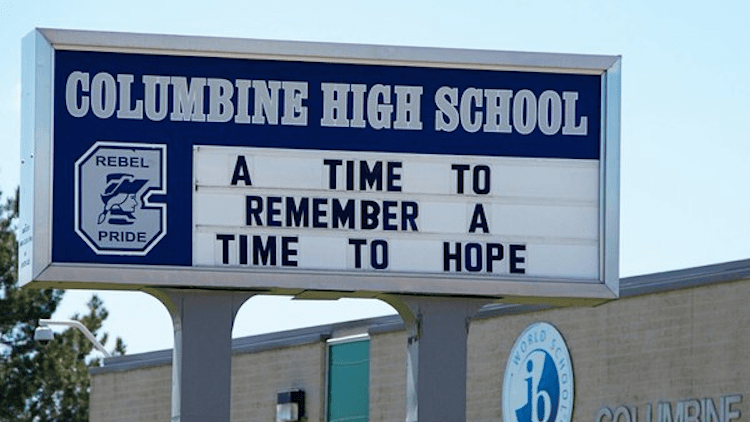 A poignant memorial at Columbine High School, featuring crosses and flowers, commemorating the victims of the 1999 shooting tragedy.