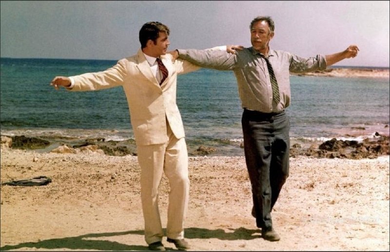Anthony Quinn as Zorba dancing with joy in the Greek countryside.